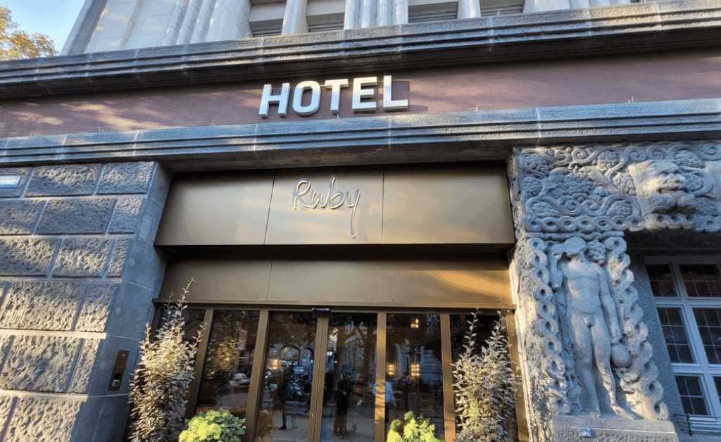 Exterior view of the Ruby Mimi Hotel & Bar in Zürich near the Main Station, featuring the neon sign and historic cinema theme.