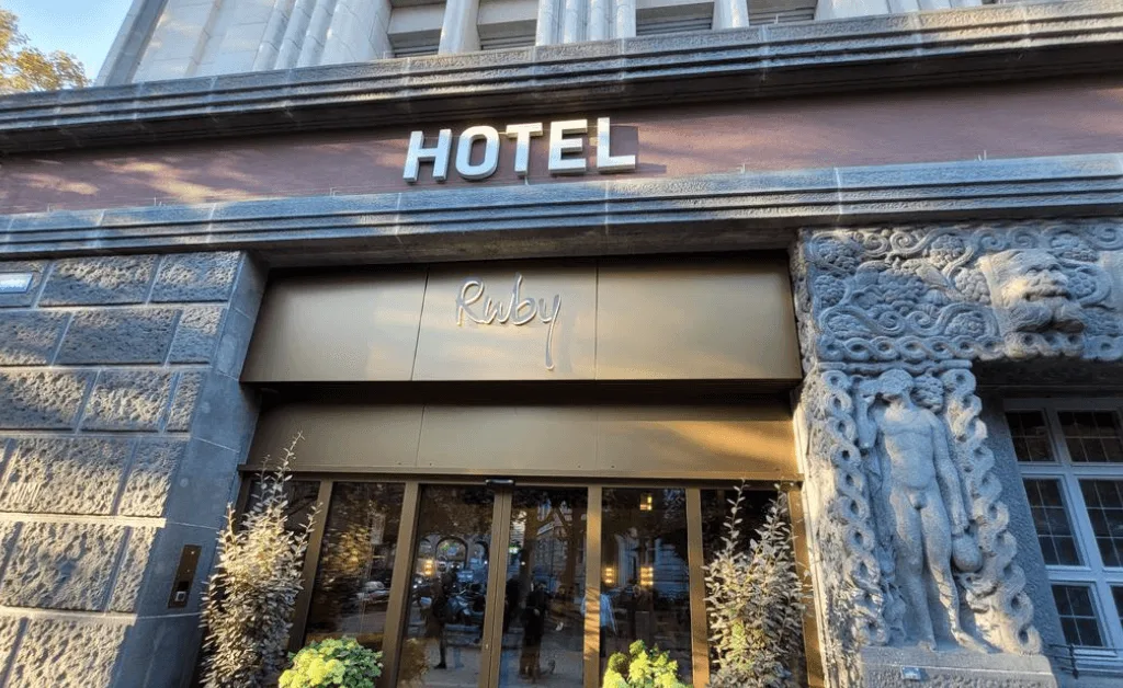 Exterior view of the Ruby Mimi Hotel & Bar in Zürich near the Main Station, featuring the neon sign and historic cinema theme.