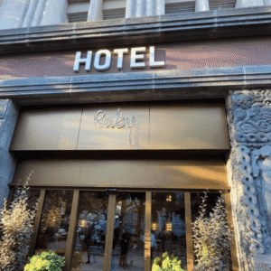 Exterior view of the Ruby Mimi Hotel & Bar in Zürich near the Main Station, featuring the neon sign and historic cinema theme.