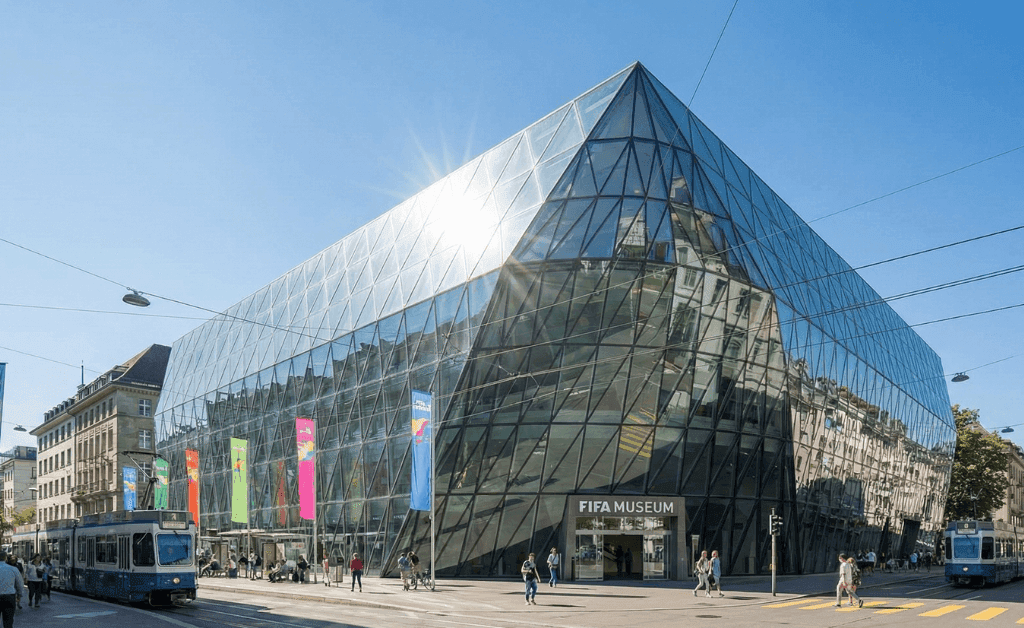 Modern glass exterior of the FIFA Museum in Zurich, Switzerland.